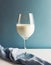 Minimalist wine glass full of milk against a blue background.