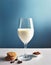 Minimalist wine glass full of milk against a blue background.