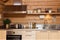 a minimalist wooden cabin kitchen with stainless steel appliances