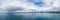Minimalistic aerial panorama- nothing but water, patch of land, and skies.