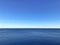 Minimalistic blue seascape with clear contrast horizon and still water