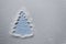 Minimalistic Christmas tree with sugar snow on a light background