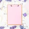 Minimalistic composition with clipboard, envelope, pen, lilac flowers and box on white background. Flat lay, top view. Freelancer