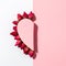 Minimalistic concept of Valentine`s day, half heart pink paper, dry rose flowers laid out on the contour of the shape of the half