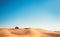 Minimalistic desert view with blue sky, sand hill and one buggy quad bike