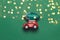 Minimalistic design for celebrating christmas or new year greeting card. Gift delivery concept. Little red toy car and Christmas