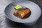 Minimalistic design Japanese salmon fish filet with vegetable and nori glazed in teriyaki sauce on a modern design plat