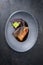 Minimalistic design Japanese salmon fish filet with vegetable and nori glazed in teriyaki sauce on a modern design plate