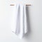 Minimalistic Japanese Style White Towel On Wooden Rack