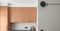 Minimalistic kitchen interior design in grey and terracotta shades. Clean kitchen interior concept.
