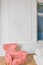 Minimalistic and luxury pastel pink home interior with velvet design armchair, big window.classical style Armchair in