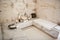 Minimalistic photo of marble Turkish bath with towels and candles