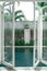 Minimalistic scandinavian interior of open glass door to swimming pool