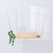 A minimalistic scene with a wooden podium on a white background hanging on chains with leaves. Place for product presentation