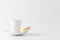 Minimalistic shot of espresso cup with one white macaroon