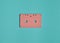 Minimalistic trend of audio technology from the 80s. Audio cassette on pastel color background