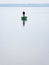 Minimalistic vertical shot of a man on the boat fishing on the lake