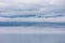 Minimalistic view of the fluffy white clouds over the calm sea