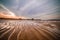 Minimalistic view of the sandy sea shore at sunset with abstract pattern