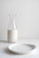 Minimalistic vintage background with an empty plate and a jug of milk in the background