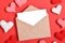 The minimum layout of a letter with an envelope on a red background is next to knitted hearts.