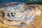 Mining from above. Industrial terraces on open pit  mineral mine. Aerial view of opencast mining. Dolomite Mine Excavation.