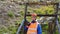 Mining engineer, a geologist in the protective reflective vest, gloves and helmet, with hammer in hand.