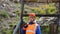 Mining engineer, a geologist in the protective reflective vest, gloves and helmet, with hammer in hand.