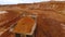 Mining truck transporting sand at sand quarry. Aerial view of mining machinery