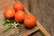 Minneola Tangelos on a rustic wood and metal surface
