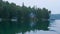 Minnesota lake shore with boats and cabins in evening light.