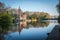 Minnewater Castle and lake panorama in Bruges