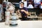 Minsk, Belarus, April 24, 2018: Composition of cups and coffee beans on background of a barman making coffee in a McCafe in McDona