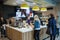 Minsk, Belarus, April 24, 2018: Interior of McCafe in McDonald`s restaurant. Bartender gives order to customer.