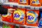 MINSK, BELARUS - February 2, 2020: A buyer purchases Tide washing powder at supermarket