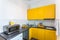 MINSK, BELARUS - JANUARY, 2019: Interior of the modern kitchen in loft flat apartment in minimalistic style with yellow color