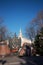 MINSK, BELARUS, JANUARY, 3, 2019, House with a spire. In the foreground is a monument to the employees of the Ministry of Internal