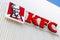 Minsk, Belarus - July 20, 2019: KFC fast food restaurant logo on white ribbed facade background, diagonal view. Kentucky