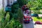 MINSK, BELARUS - JUNE 20, 2020: Big red fire engine cars with firefighters and emergency ladders near the building on the street.