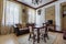 MINSK, BELARUS - MAY 2020: Interior of vintage biedermeier interior guestroom in studio apartments with sofa table chairs and tv