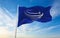 Minsk, Belarus - May, 2021: Flag of Union of South American Nations, UNASUR waving in the wind at flagpole on background of blue