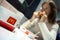 MINSK, BELARUS - October 4, 2019: Big Mac Box on table against background of a woman who dines in a McDonald`s restaurant.