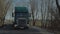 MINSK, BELARUS- SEPTEMBER 10, 2018: A Scania truck convoy is moving along a country road through a forest