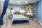 MINSK, BELARUS - SEPTEMBER, 2019: Interior of the modern luxure bedroom in studio apartments in blue light color style