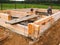 Minsk Region. Belarus. February 24, 2016. Workers drill holes for driving Nagel. construction of bony from natural wood