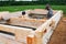 Minsk Region. Belarus. February 24, 2016. Workers drill holes for driving Nagel. construction of bony from natural wood