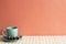 Mint coffee cup with eucalyptus leaf on mosaic tile table