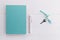 Mint color notebook with home keys and a pen concept of planing a house buying, mortgage, debt or property loan or gift