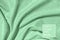 Mint colored draped fabric with silver lurex thread