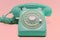Mint Colored Retro Style Rotary Phone on Pink Background